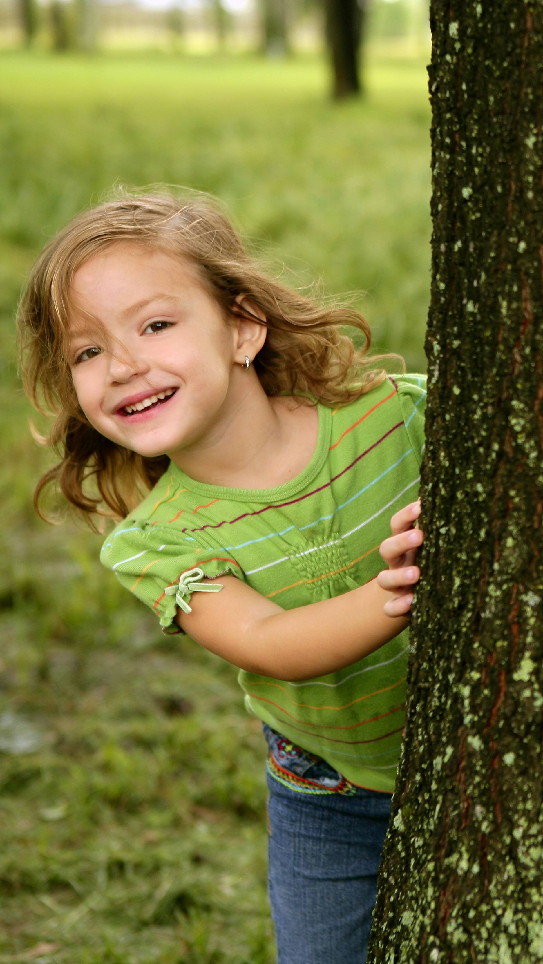 girl-playing-behind-tree - Speech Buddies Blog